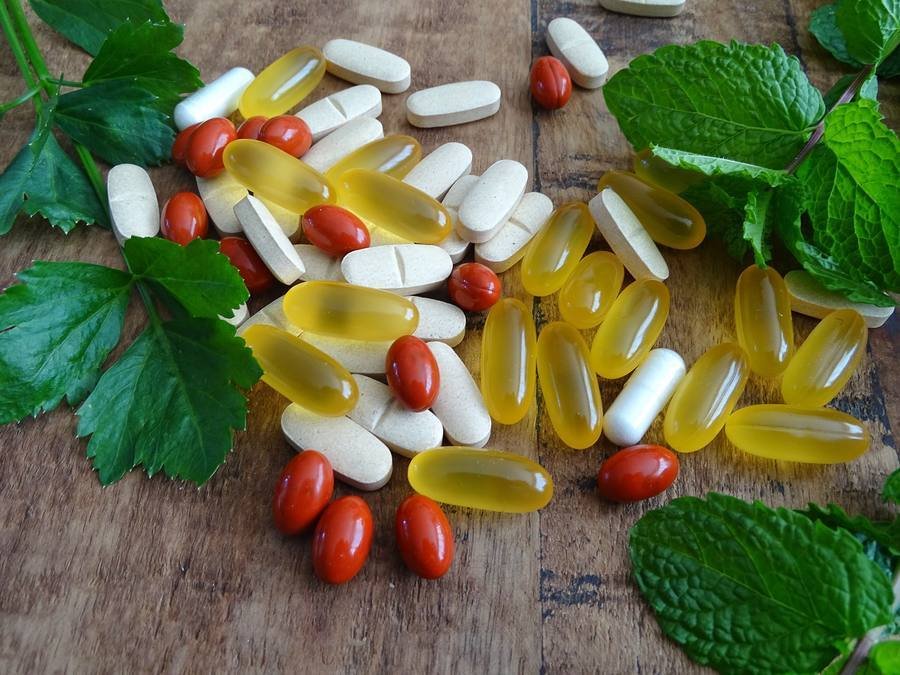 Natural supplements and vitamins for nerve health on wooden table
