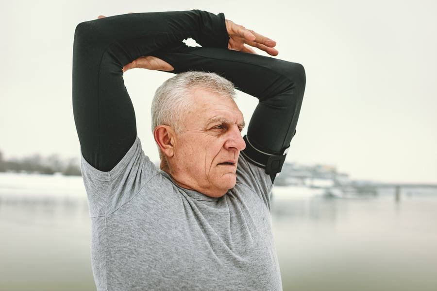 Senior man stretching outdoors demonstrating active lifestyle for nerve health support
