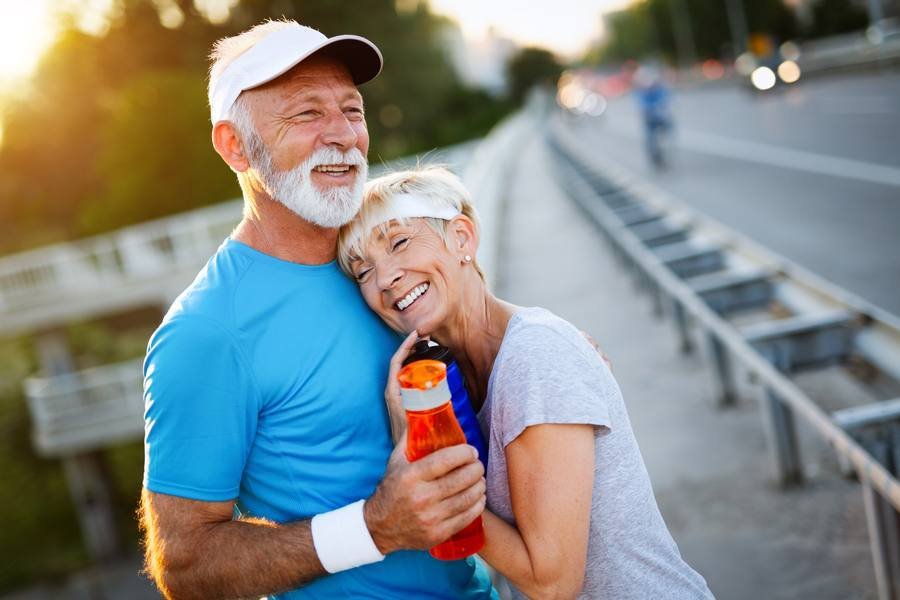 Active senior couple exercising outdoors — cardiovascular health supports cochlear blood flow and hearing