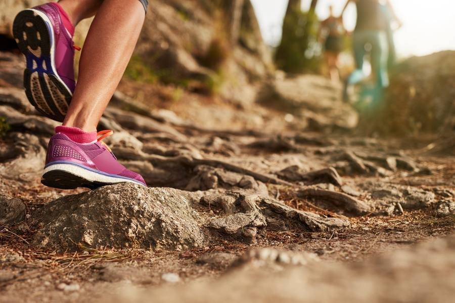 Walking shoes on rocky trail — proper footwear for fitness walking after 40