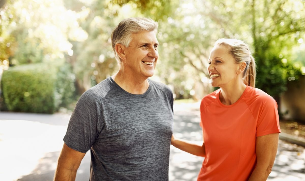 Mature couple walking outdoors for exercise and blood sugar management