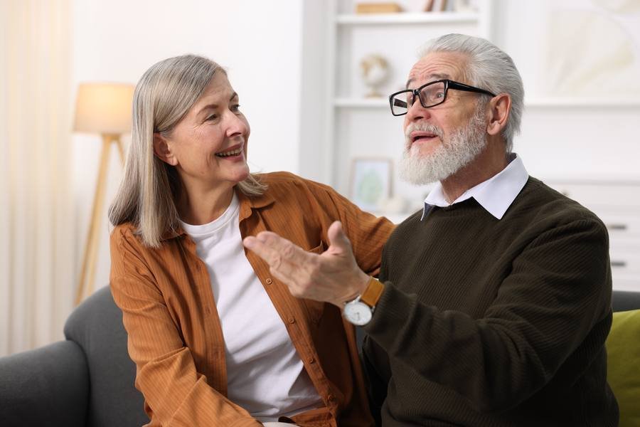 Senior couple having a conversation at home — age-related hearing changes affect communication