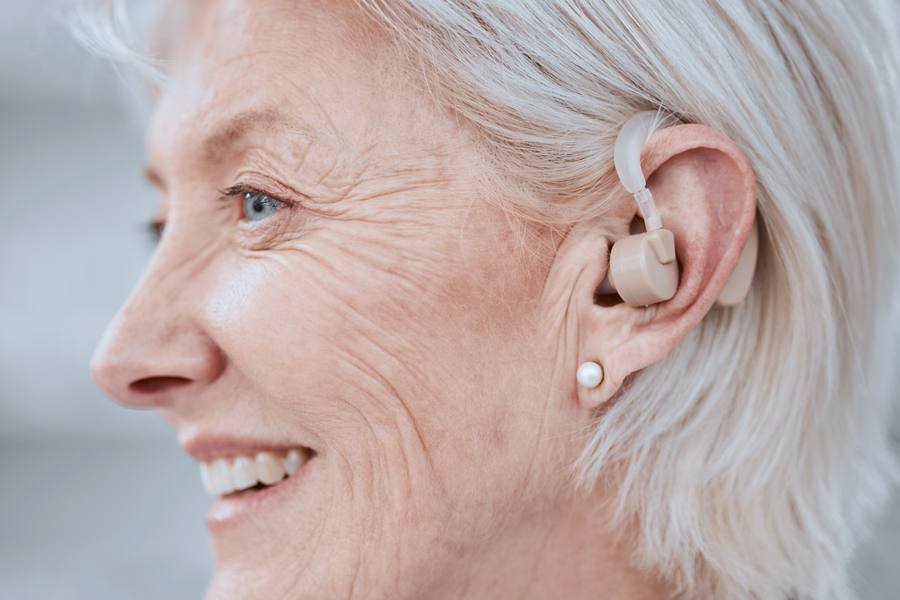 Senior woman with modern hearing aid — early intervention produces significantly better outcomes