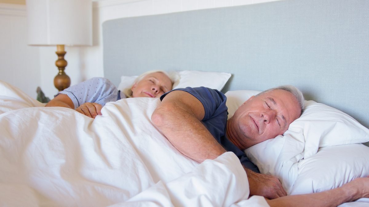 Mature couple sleeping well — quality sleep is critical for blood sugar management after 40