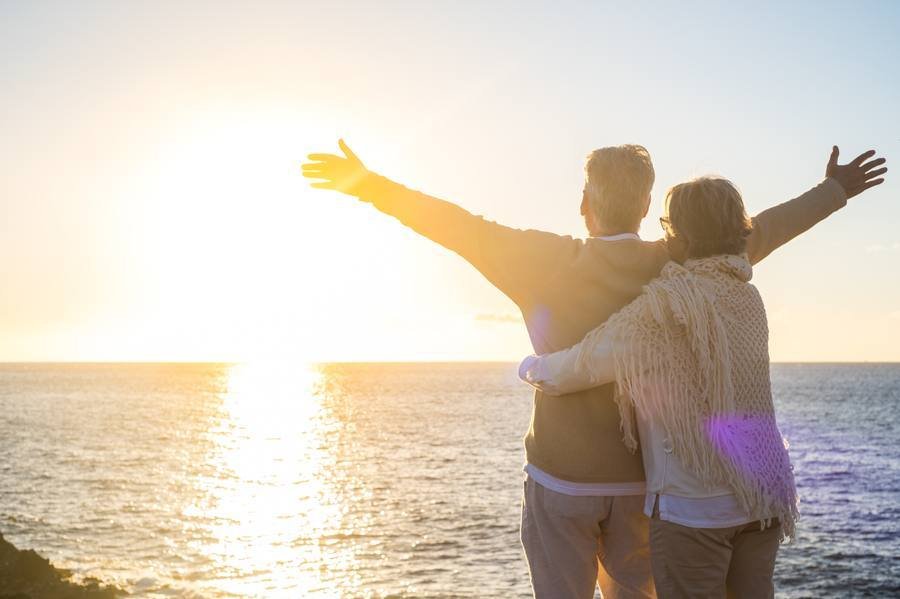 Senior couple enjoying sunlight by the ocean — natural vitamin D synthesis for blood sugar support