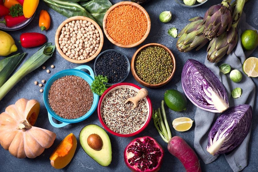 Colorful variety of fiber-rich foods including legumes, seeds and vegetables for blood sugar support