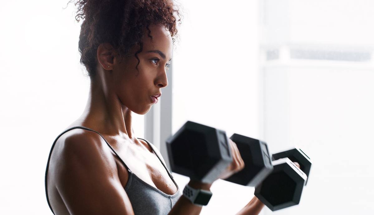Woman doing resistance training exercise with dumbbells